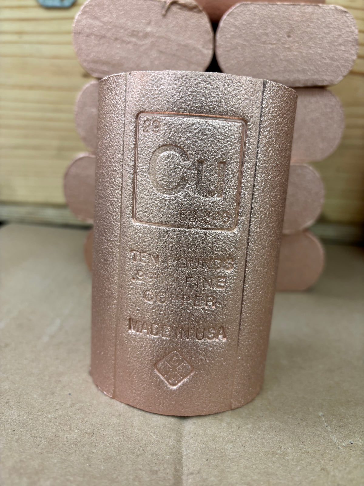 A copper-colored cylindrical .9999 Fine copper bullion rod