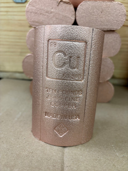A copper-colored cylindrical .9999 Fine copper bullion rod
