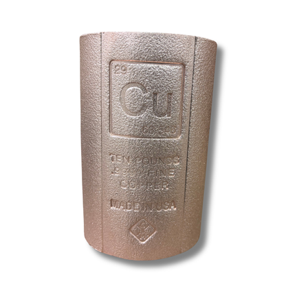 A ten-pound cast copper , featuring a textured metallic copper finish with embossed text and a periodic table of elements design, shown on a white background with a soft drop shadow.